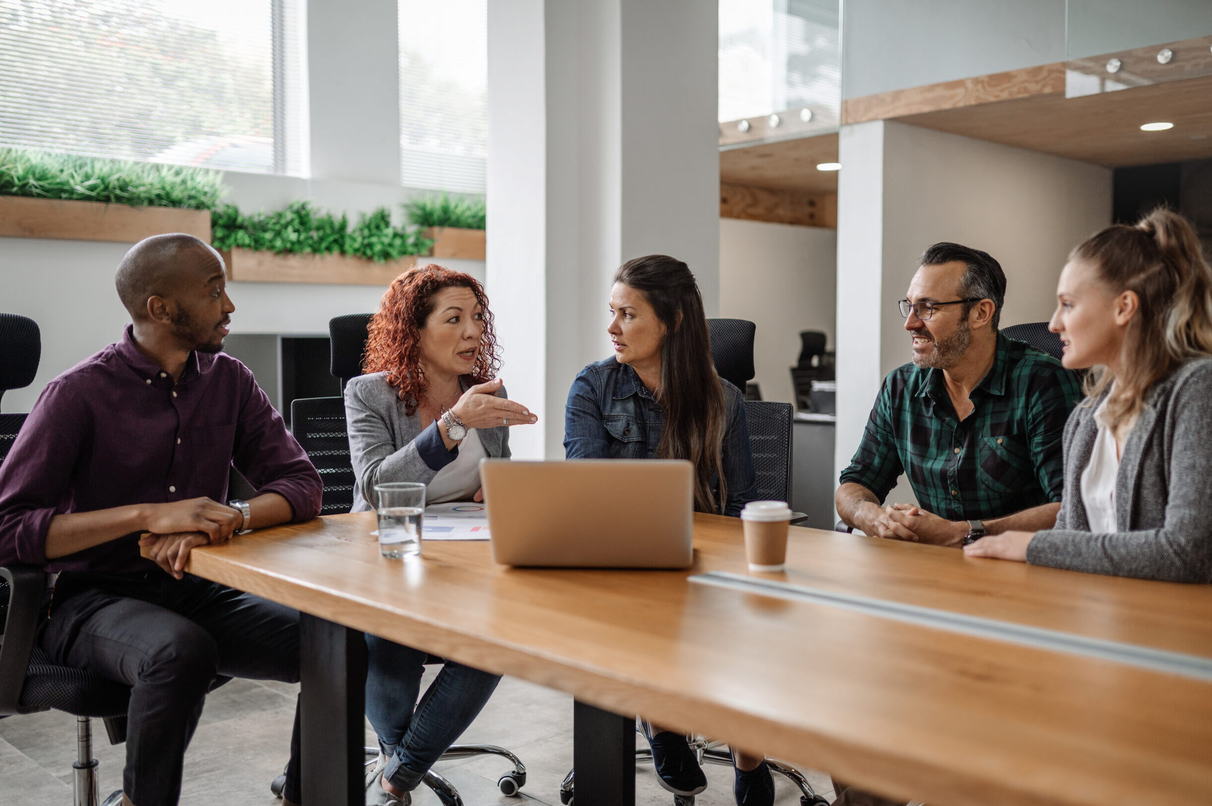 Diverse team of businesspeople having a meeting around a table